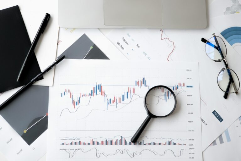 Magnifying glass on charts showing cloud cost optimisation data and trends