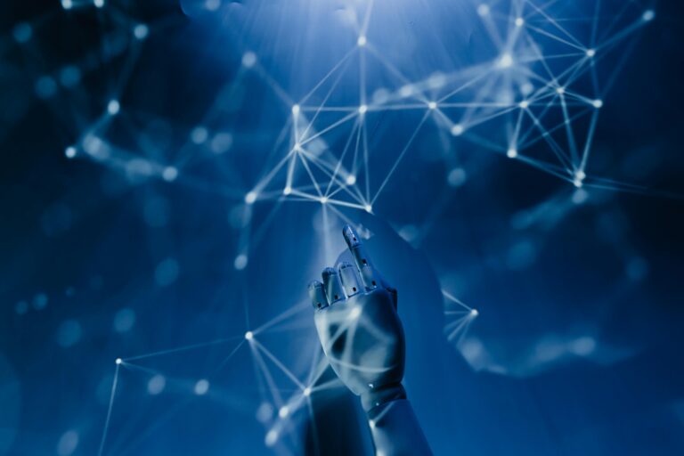 AI in the cloud: A robotic hand touches an abstract blue digital network, representing intelligent automation and optimised data operations.