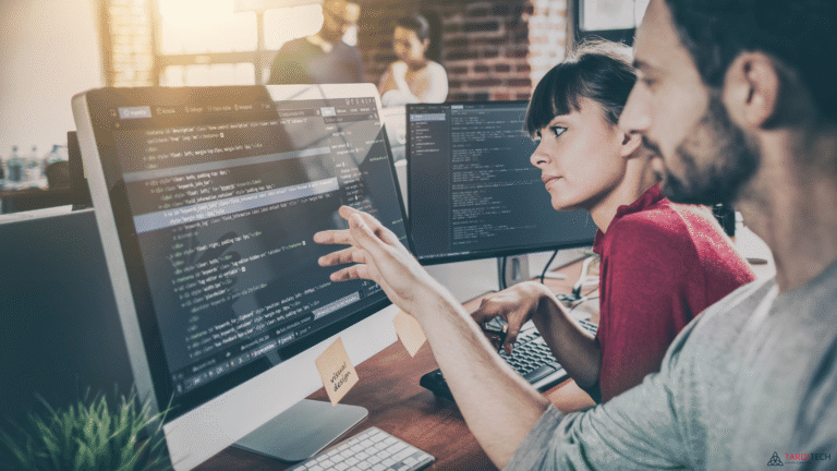 Two software developers reviewing code together, representing DevOps collaboration and shared responsibility