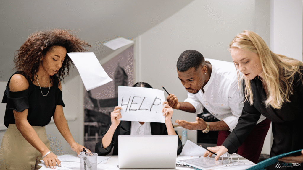 Overwhelmed employee holding a help sign while colleagues work around them, representing DevOps team strain